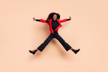 Fototapeta na wymiar Full body photo of dark skin funky positive young woman jump up air enjoy weekend isolate don beige color background