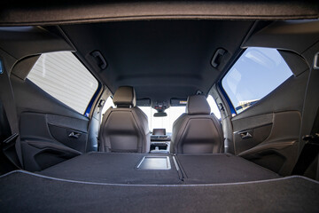 empty trunk of a modern car with folded rear seats. large interior volume. trunk view
