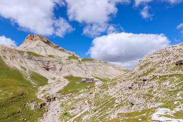 Fototapeta premium Beautiful mountain peaks of the Italian Dolomites and mountain hut (Rifugio Puez)