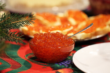 Red caviar. Lots of red caviar. New year concept.Feast with red caviar. New Year's festive table.Christmas.Christmas festive table.Red caviar with a spoon on the table.Sandwiches with red caviar 