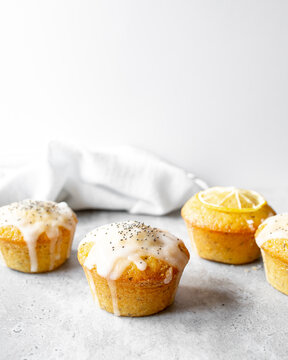 Lemon Poppy Seed Muffins On A Concrete Worktop And Bright Grey Background.