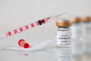 Vial  with COVID-19 vaccine and syringe. Closeup.
