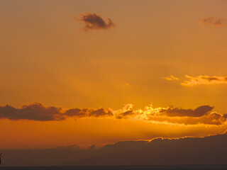 Fototapeta na wymiar Sun setting behind clouds 