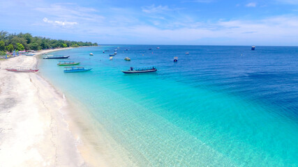 Fototapeta na wymiar Tropical island with white sandy beach and blue transparent water