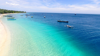 Tropical island with white sandy beach and blue transparent water