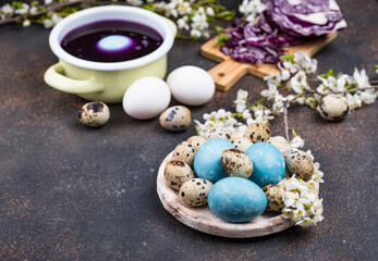 Fototapeta na wymiar Process of painting Easter eggs in blue