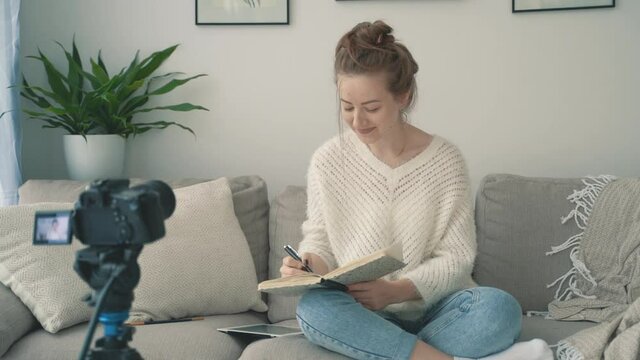 Camera recording a video tutorial. Streamer at home. Young female artist.