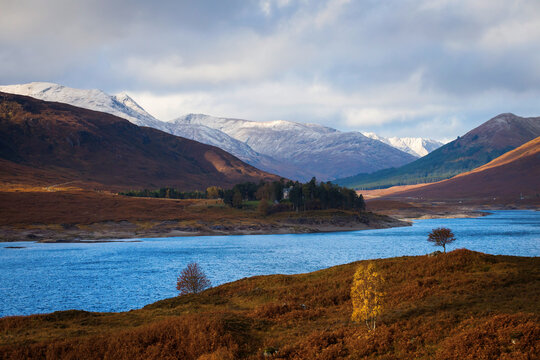 Autumn landscape in Highlands, Scotland, United Kingdom. Beautiful mountains with snow in background. © danmir12