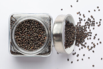 Close up of Organic Black Gram (Vigna mungo) or whole black urad in a glass jar with Lid. Top view 