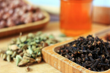 Clove sticks, cardamom and honey