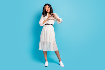 Full length body size view of attractive cheerful amazed girl showing heart sign isolated over bright blue color background