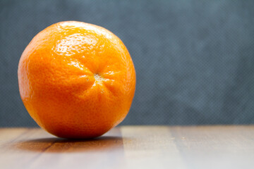 sliced mandarin on wooden table with black background