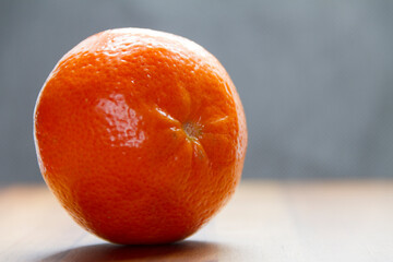 sliced mandarin on wooden table with black background