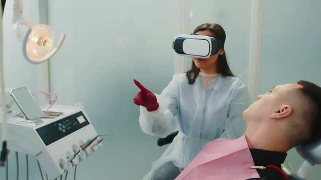 Female dentist looking at BP glasses x-ray of patient. Modern dentistry. Dentistry with virtual reality.