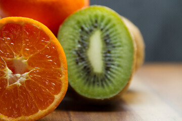 mandarin and kiwi on a wooden table