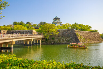 Osaka, Japan - April 30, 2017: Golden Wasen, a touristic boat, along the moat of Osaka Castle and...