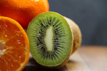 mandarin and kiwi on a wooden table