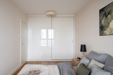 Bedroom with big white wardrobe