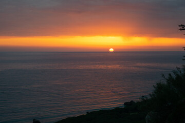 Dramatic colorful sunset read and orange sky over the Atlantic Ocean in Punta Paloma, Tarifa, Spain
