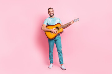 Full length body size view of attractive cheerful guy playing string guitar country isolated over...