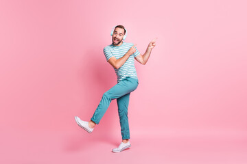 Fototapeta na wymiar Full length body size view of nice funky childish cheerful guy listening melody having fun fooling isolated over pink color background
