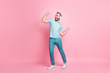 Full length body size view of nice cheerful guy listening melody rock bass having fun dancing isolated over pink color background