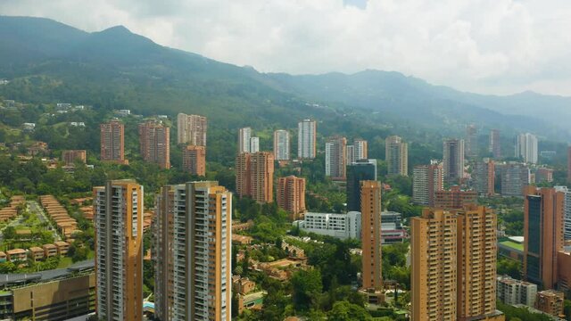 Drone Descending Above El Poblado Neighborhood on Cloudy Day in Medellin, Colombia