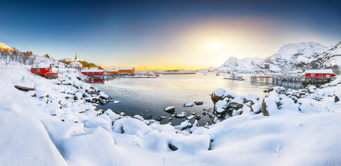 Stunning winter scenery of Moskenes village with ferryport and famous Moskenes parish Churc