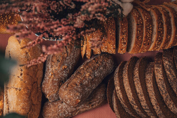 Gold rustic crusty loaves of bread and buns. Bakery concept.