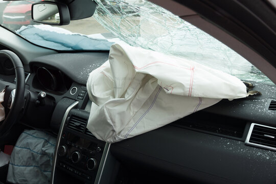 Interior of a automobile or car involved in a vehicle crash with a deployed passenger side airbag