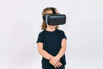 Little girl wearing virtual reality glasses with arms crossed, on white background