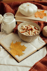 oatmeal bowl with nuts and cup of milk