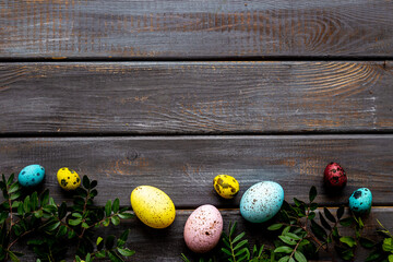 Colorful eggs with green tree. Easter decoration background. Top view