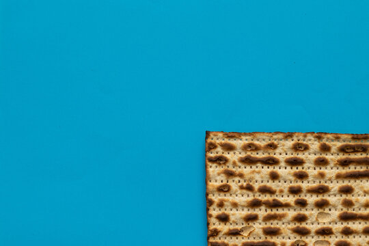 A close-up of a matzah - bread for the Jewish Passover, on a light blue background
