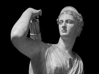 Classic white marble statuette Diana of Versailles isolated on black background. Scilpture of...