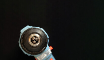 Quick-release screwdriver chuck on a black background. Selective focus.
