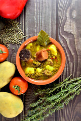 Lentil stew with chorizo and blood sausage, served in a clay plate. Typical of Spanish cuisine....