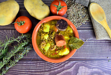 Typical of Spanish cuisine. Lentil stew with chorizo ​​and blood sausage, served in a clay...