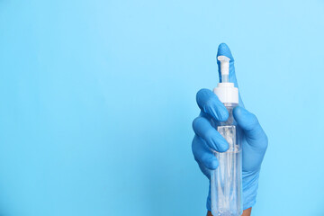 man hand in medical gloves holding sanitizer gel for preventing virus 