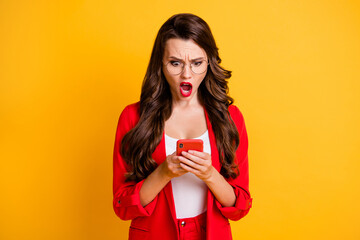 Photo of cute confused lady hold telephone open mouth wear red jacket spectacles isolated vibrant yellow color background