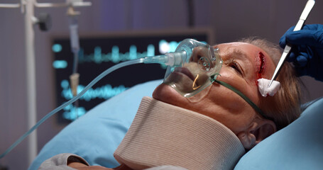 Close up of medical staff cleaning wound of injured senior woman