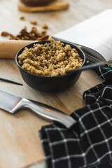 Cooked quinoa porridge is on the table along with salad. Cooking process in the kitchen. Kitchen utensils and ambiance.