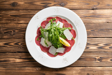 Beef carpaccio with arugula parmesan cheese and lemon