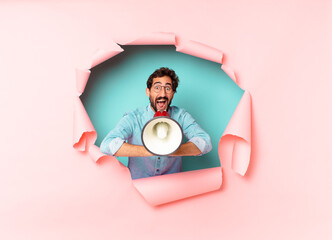 young crazy bearded man. happy and surprised expression. megaphone concept