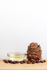 Banner, organic cosmetics concept, glass bottle with oil, cedar on light wooden background