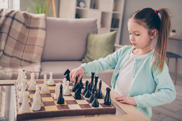 Photo of school girl look interested hand hold chess figure ponder thinking learn free time weekend...