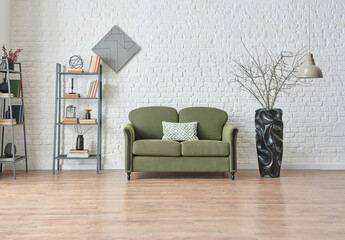 Green sofa in the living room with brick wall background and frame style, bookshelf lamp decor.