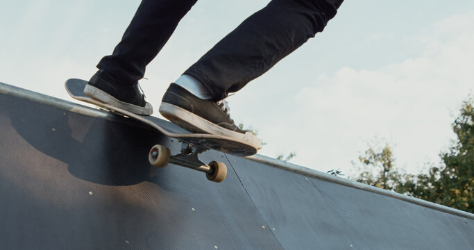 Young male adult skateboarding halfpipe miniramp grinding and makes tricks