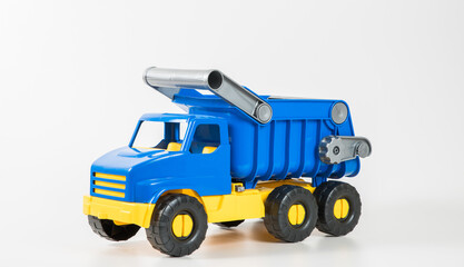 Plastic car. Toy model isolated on a white background. Yellow-blue truck with a body.