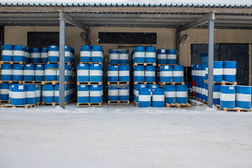 Outdoors warehouse. Group of stacked barrels with motor oil lubricant.